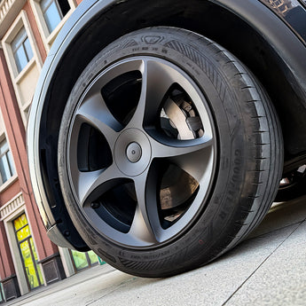 Matte black multi-spoke wheel cover on tire, 19-inch with center cap