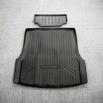 Dark gray Model S trunk liner mat with ridged grooves and molded side channels