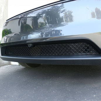 Black front bumper grille with wire-mesh insert, mounted on vehicle front.