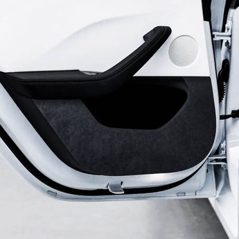 Black suede anti-kick door panel protector close-up with curved edge and cutout.