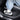 Footwear on black carbon-fiber door sill scuff protector with “MODEL Y”