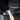 Hand wiping a black carbon-fiber door sill protector panel