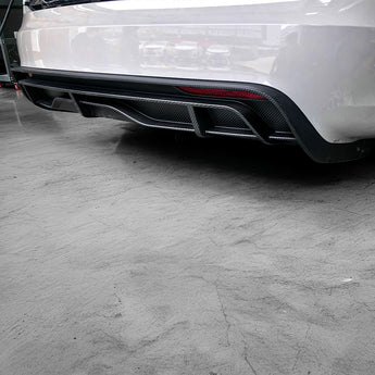 Installed black carbon fiber rear diffuser with angled fins and red trim line