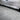 Vehicle side skirt showing dark carbon fiber trim and integrated aero lip.