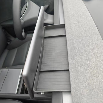 Center dashboard storage tray, light gray with ribbed texture and open front compartment