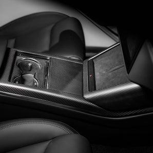 Carbon fiber console side trim with dark weave texture near center console