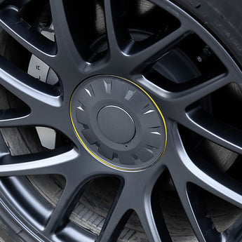 Close-up of silver wheel hub cap with yellow accent ring