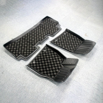 Set of checkered floor mats with rubber edging and textured grip ridges