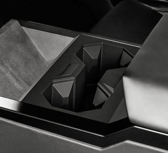 Black cup holder insert with molded slots and central divider, angled view