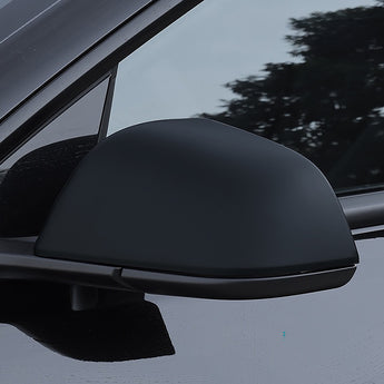 Tesla side mirror cover in solid dark black, smooth glossy surface