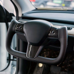 Black steering wheel with textured side grips and yoke center panel