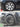 Cyclone-style hubcap replacement on a front wheel, dark multi-spoke design