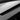 Light gray dashboard panel with carbon fiber air vent trim strip and silver edge