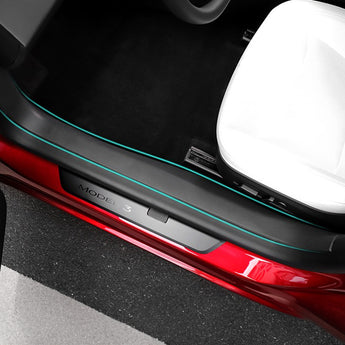 Installed door sill protector with black finish and blue edge trim on red door
