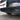 Front bumper grille insert corner view with diamond-pattern mesh and dark slat trim