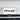Black anti-theft license plate holder with YE5LAK plate on front grille