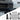 Front license plate holder mounted on vehicle bumper with included mounting hardware pieces