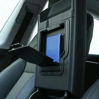 Car armrest storage box in rear seat, lid open showing blue insert