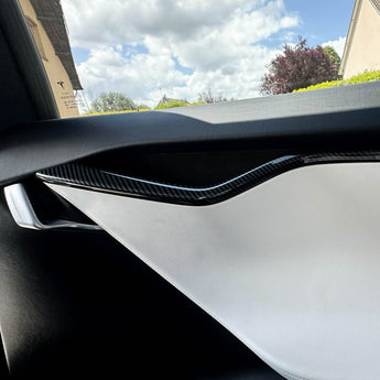 Glossy carbon-fiber door trim strip on interior door panel edge