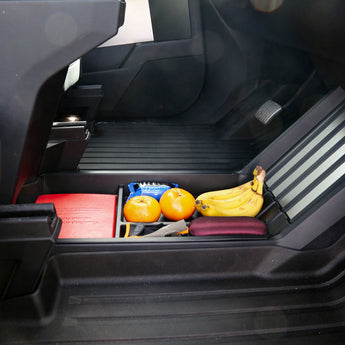 Black organizer insert in center console with divided compartments and grooved base