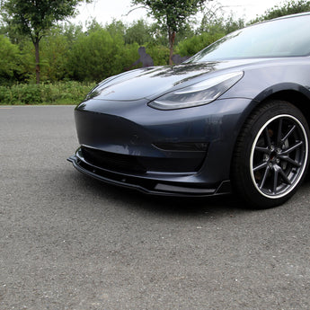 Front lip spoiler for Model 3 in glossy black ABS, attached to front bumper