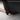 Hand holding black mud flap panel to show fit under the vehicle