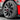 Silver wheel cover on tire, multi-spoke aero rim protector.
