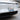 License plate holder mounted on a light gray car front with plate frame