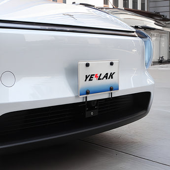 License plate holder mounted on a light gray car front with plate frame