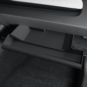 Drawer-style glove box organizer drawer open with molded compartments, dark gray