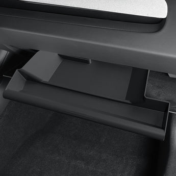 Drawer-style glove box organizer drawer open with molded compartments, dark gray