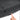 Close-up of black trunk sill protector slot area with hand pointing to opening