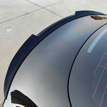 Blade-style rear spoiler for Tesla Model 3, dark black trim with curved edge.