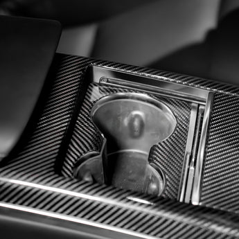 Carbon fiber cup holder trim insert with textured weave around round cup opening