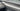 Light gray carbon fiber trim cover strip on inner door panel near handle area