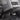 Black carbon fiber rear console base cover with weave pattern and side openings