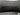 Black TPE trunk lid protector mat installed, with textured surface and center fastener