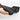 Black TPE trunk lid protector mat with textured edge trim in hand