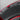 Rear trunk lid cover mat close-up with ribbed grooves and round mounting holes