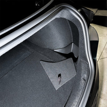 Rear trunk side storage bin with gray carpet liner and silver metal border