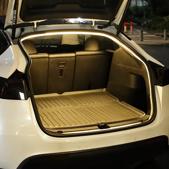 LED trunk light strip installed around open cargo area, warm white glow