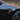 Side camera trim cover with carbon-fiber pattern and silver accents on dark door