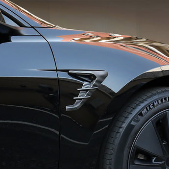 Side camera trim cover with carbon-fiber pattern and silver accents on dark door