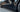 Vehicle side with glossy black ABS side skirt trim along the rocker panel edge