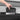 Hand removing black storage box from door organizer slot for Tesla Cybertruck