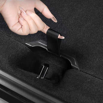 Hand pulling a black trunk pull strap handle from the trunk opening