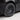 Wheel cover close-up on a dark car corner, showing multi-spoke design