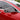 Matte carbon fiber side mirror cover on a red car door