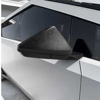 Dark carbon-fiber mirror cap installed on a vehicle side mirror
