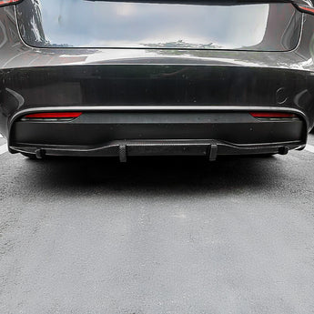 Tesla Model 3 carbon fiber rear diffuser installed under rear bumper with fins